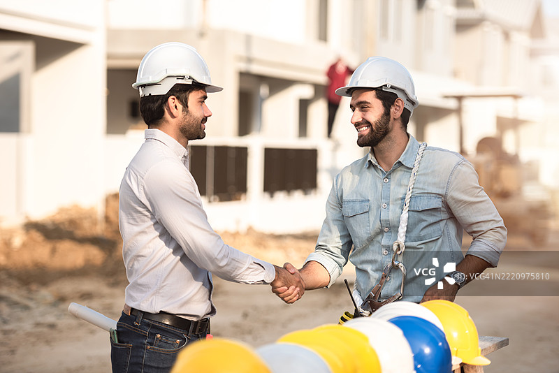 建筑工人、土木工程师和建筑师在泰国的建筑工地握手图片素材