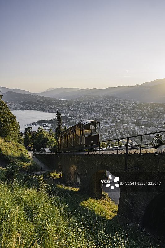 缆车在湖泊和城市上方的山上行驶图片素材