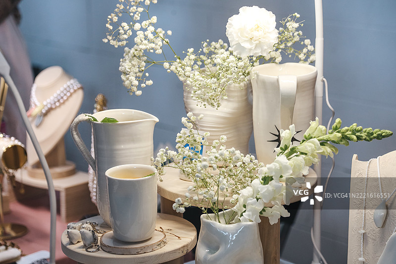 当地跳蚤市场的手工陶瓷花瓶、杯子、水壶和珠宝角落图片素材