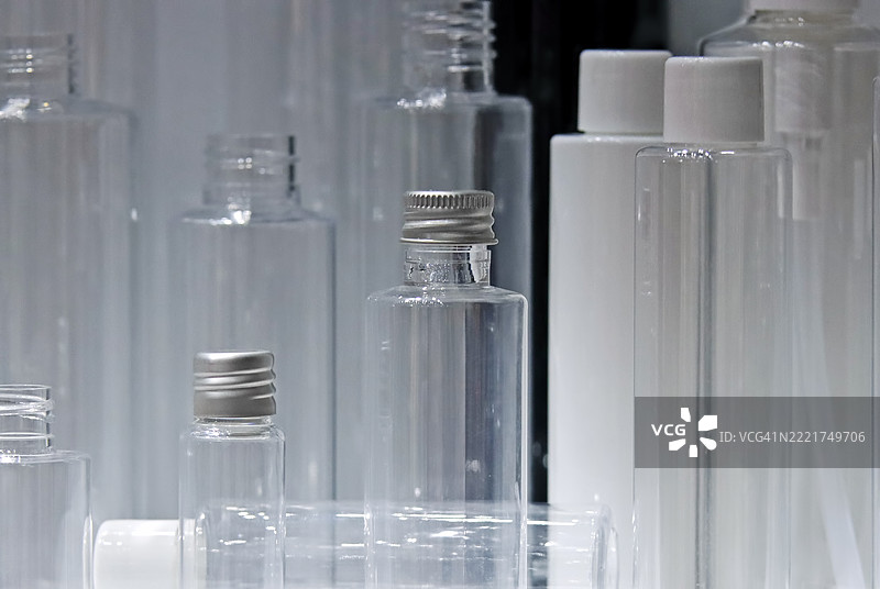 多种不同的透明空塑料瓶，配有香水或其他液体的泵式分配器图片素材