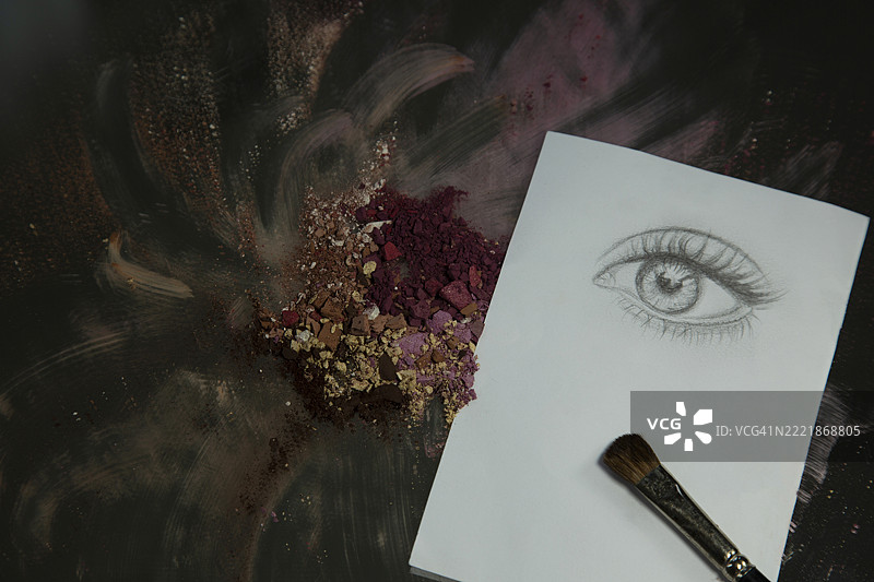 碎眼影与纸张、眼睛素描和化妆刷在一起图片素材
