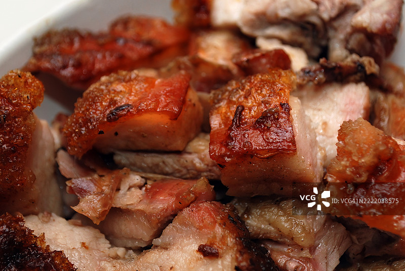 特写镜头展示了切成小块的烤五花肉。图片素材