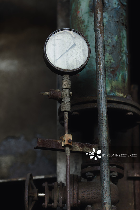 生锈的旧管道和一个测量仪表图片素材
