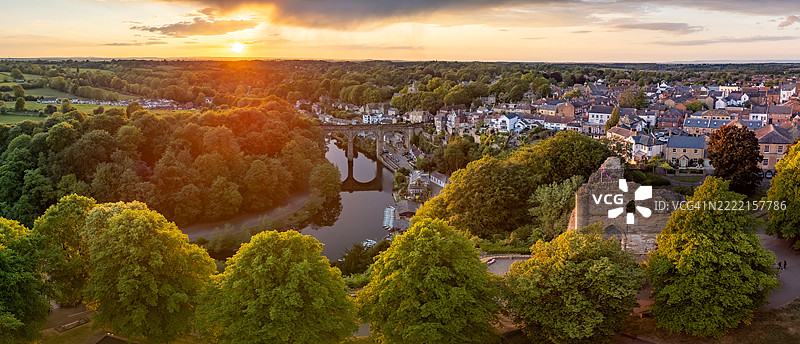 从空中俯瞰英格兰北约克郡的市场小镇克纳斯堡的夏季日落，能看到著名的城堡遗址和横跨尼德河的铁路高架桥。图片素材