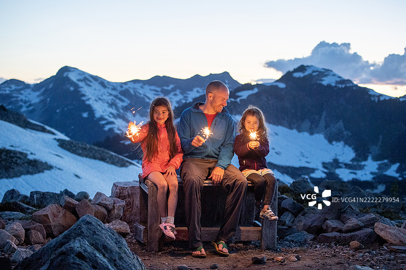 在山顶上与烟花棒的家庭图片素材