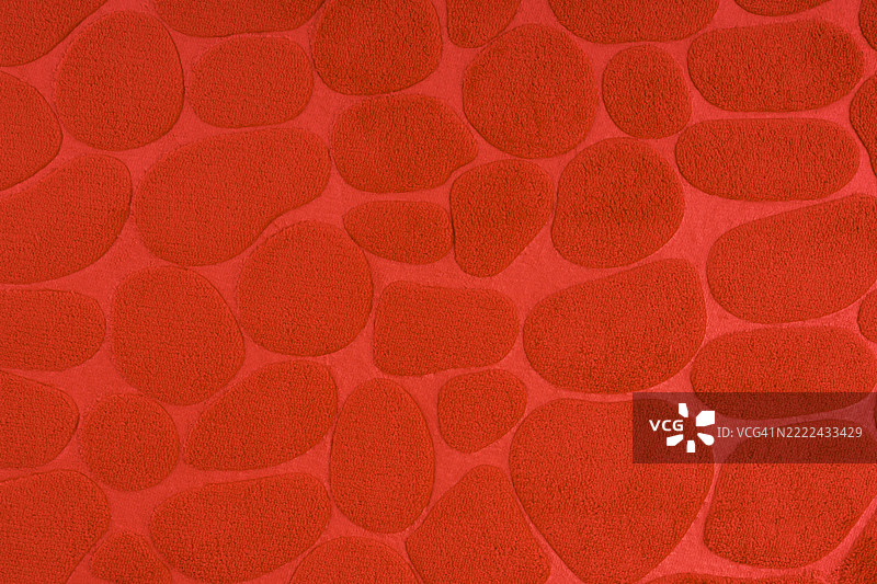 红色毛绒地毯纹理，作为背景的抽象图案。图片素材