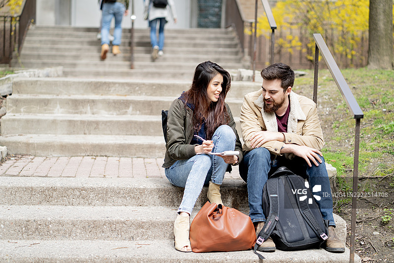 大学生在春天的校园楼梯上一起学习图片素材