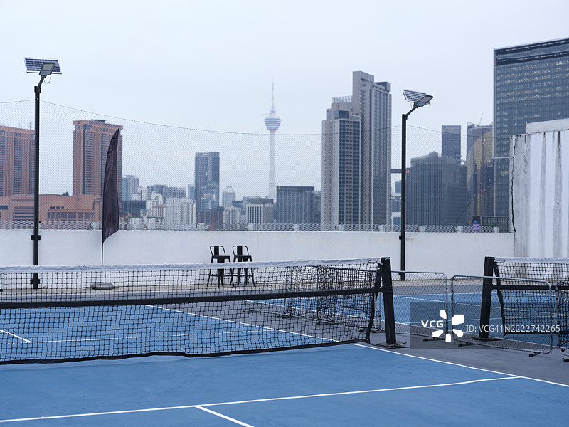 现代屋顶运动场与城市天际线景观图片素材