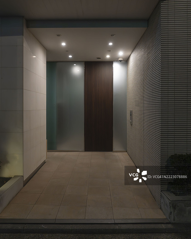 现代住宅楼夜间入口，照明走廊图片素材