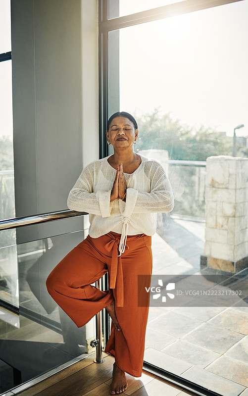 宁静的女性在自然光中练习瑜伽图片素材