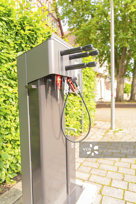 德国卡尔夫区纳戈尔德的铺装地面上的自行车修理站，背景有树木。图片素材