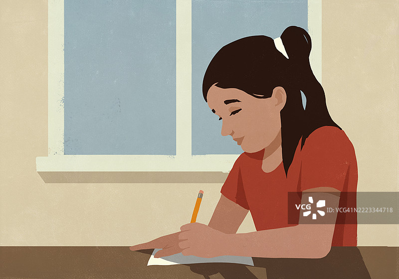 专注的女学生在窗边教室里做作业图片素材