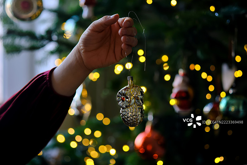 一个10岁的亚洲女孩正在快乐地装饰圣诞树。图片素材