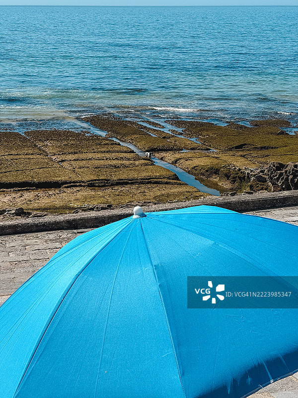卡斯凯什海滩上的蓝色沙滩伞图片素材