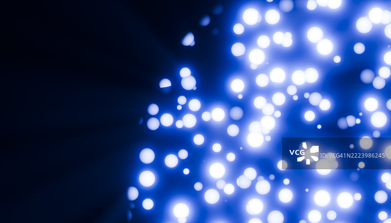 抽象的蓝色散景背景，带有发光的圆形颗粒图片素材