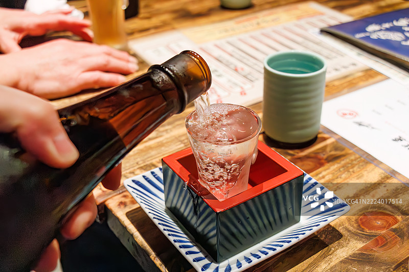 我们喝的是来自静冈县的Isojiman大吟酿。酒杯、枡和盘子都装满了。图片素材