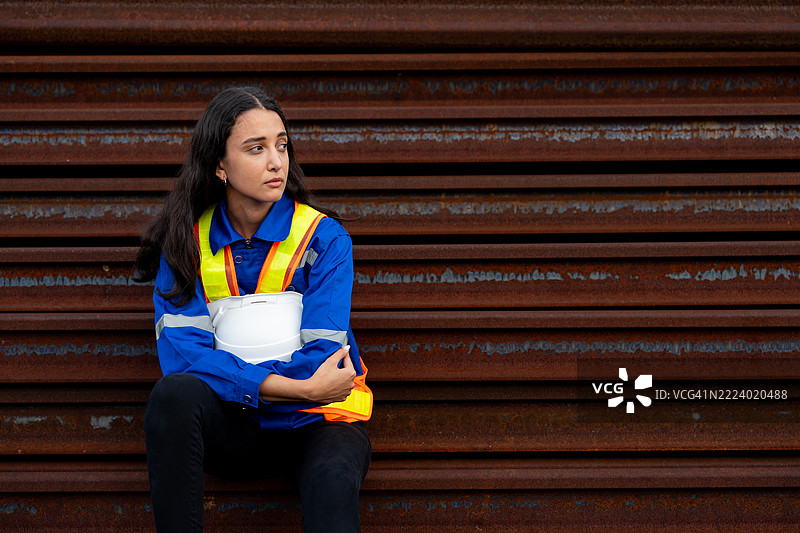 失业的蓝领工人坐在工业场地上图片素材