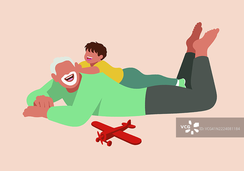 一个快乐的孙子顽皮地躺在微笑的祖父背上，他们共享着欢乐和亲密的时刻，旁边有一架玩具飞机。图片素材