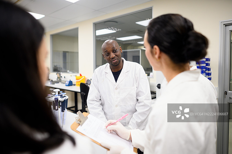 科学家们在现代实验室中合作，进行科学讨论。图片素材