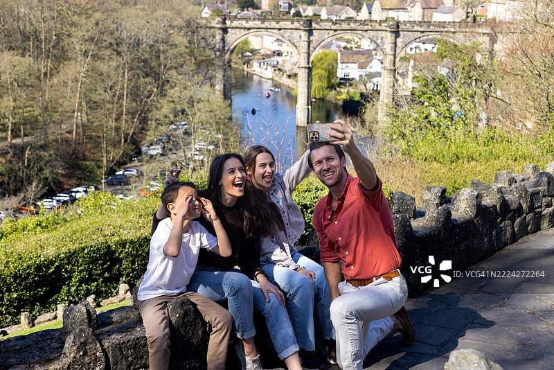 快乐的家庭在风景如画的假期中自拍图片素材