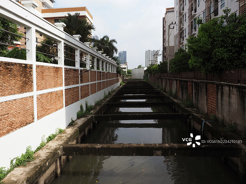 View of canal in urban district flowing slowly canal exudes tranquil atmosphere,Inviting contemplation of environment and surroundings,Thailand图片素材