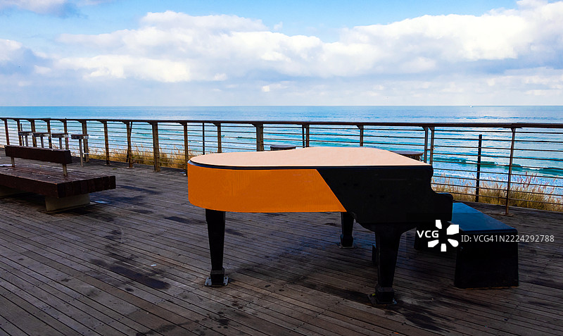 阳光明媚的日子里，海边的一架钢琴图片素材