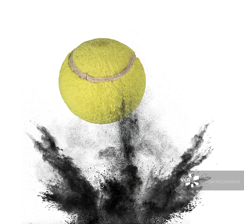 网球在白色背景上猛烈反弹，扬起一阵尘土。图片素材