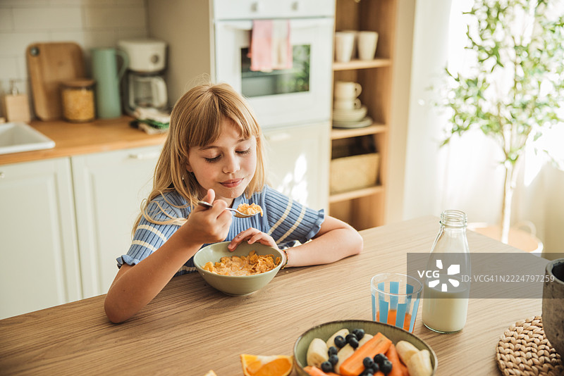 可爱的小女孩在吃谷物早餐图片素材
