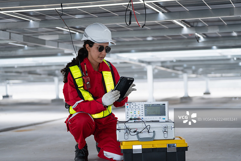 工程师团队在工厂屋顶上工作，检查、维护和服务大规模太阳能电池板安装，以实现可持续的可再生能源发电和工业效率。图片素材