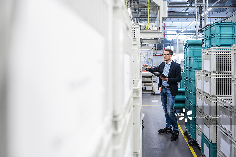 员工在生产车间使用平板进行检查图片素材