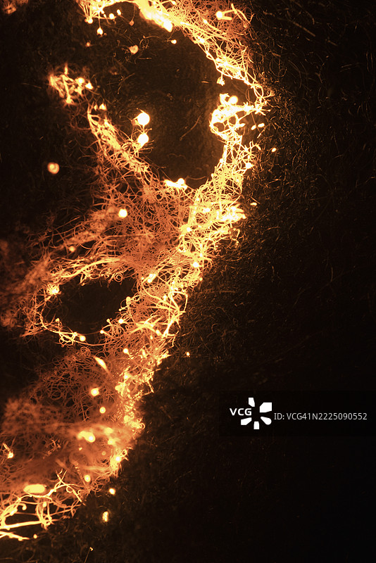 钢丝绒火花在黑暗中形成发光的抽象图案图片素材