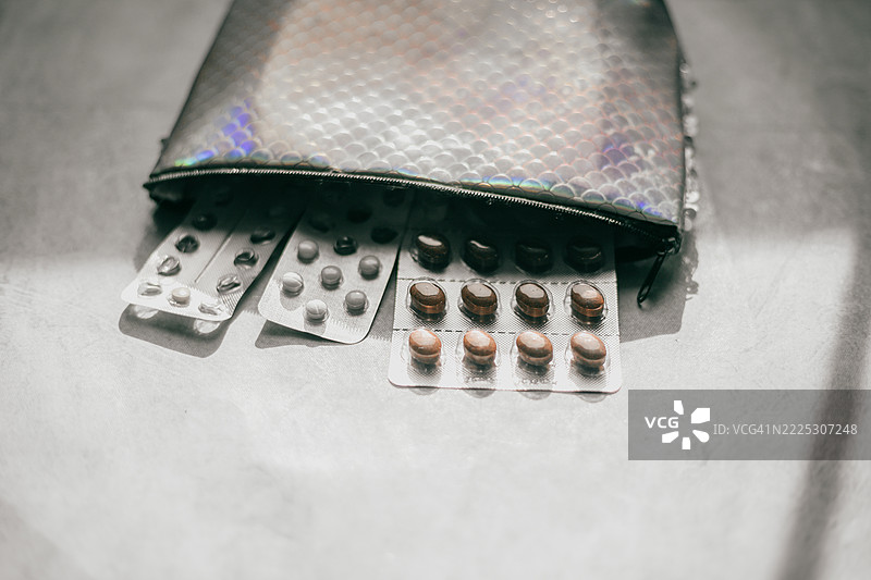 打开的洗漱包，里面装满了各种药片的泡罩包装图片素材