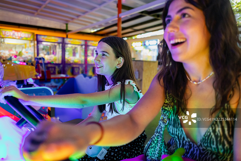 女孩和年轻女性在玩街机游戏图片素材