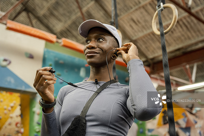 女性在健身房佩戴入耳式耳机图片素材