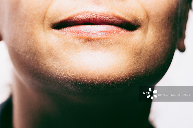 女性下半张脸特写，展现自然的嘴唇和皮肤纹理。美丽、自然肌肤和真实外观的概念。图片素材