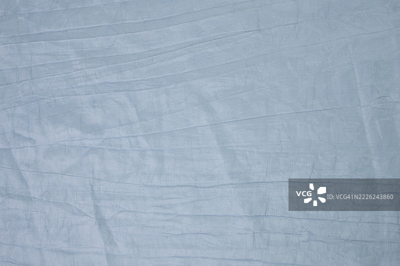 褶皱的浅蓝色布料背景图片素材