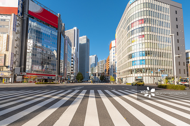 现代高楼大厦环绕的城市区域宽阔人行横道，东京，日本图片素材