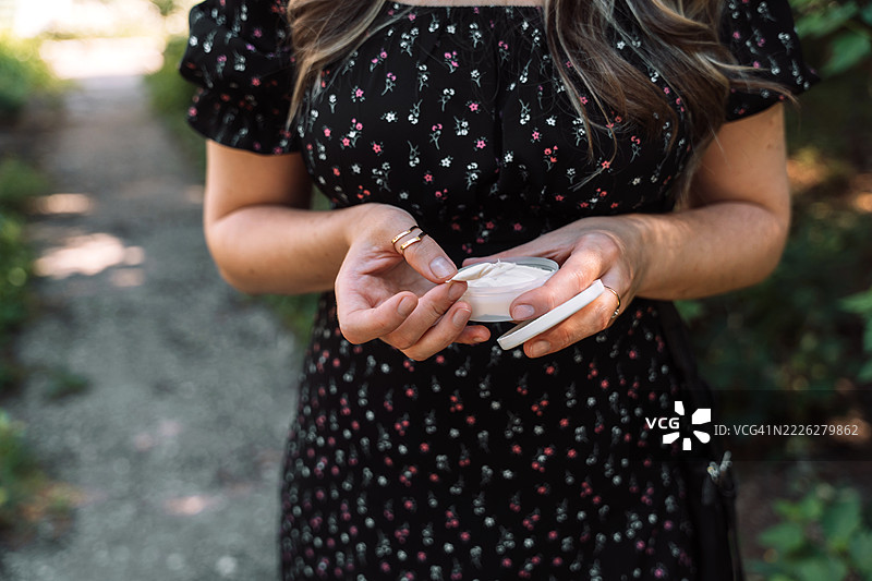 女人双手拿着一罐打开的烟草产品图片素材