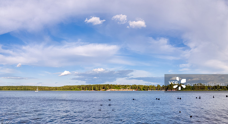 宁静的湖泊在多云的天空下延展图片素材