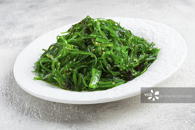 海藻制作的Chuka沙拉，配有芝麻酱，盛放在白色盘子上，无人。图片素材