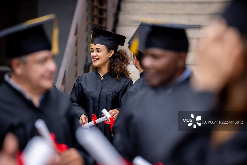 快乐的女学生在毕业典礼上脱颖而出图片素材
