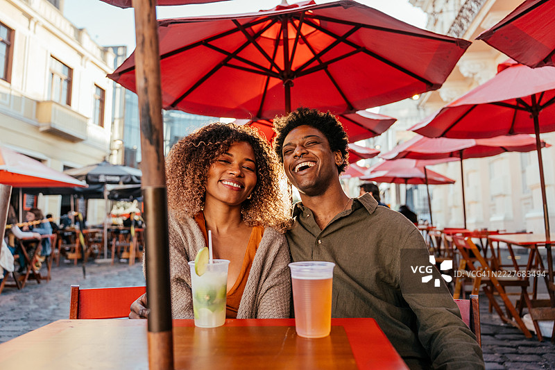 游客情侣在市中心的酒吧里喝啤酒图片素材