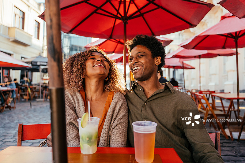 游客情侣在市中心的酒吧里喝啤酒图片素材