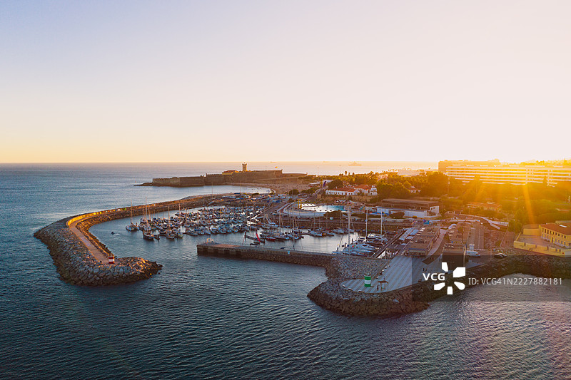 葡萄牙奥埃拉什，码头停泊着一艘帆船，金色落日天空，航拍视角图片素材