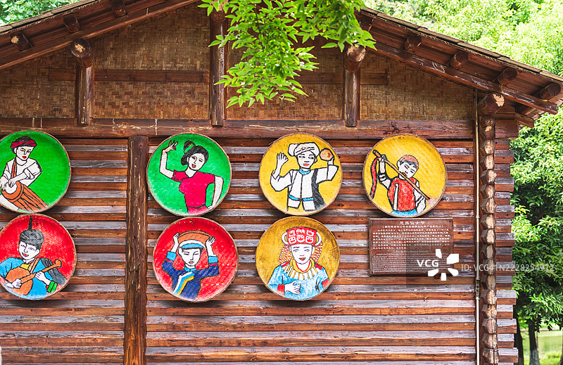 色彩斑斓的传统艺术画作挂在木墙上图片素材