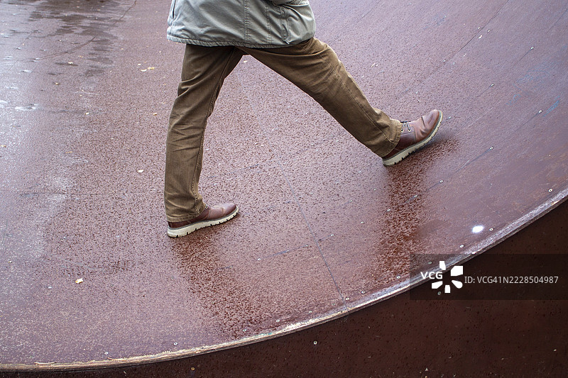 一名男子在城市公园的滑板坡道上行走图片素材