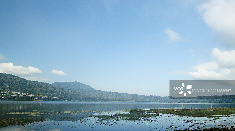 巴厘岛贝杜古尔潘查萨里村布扬湖上塔帕克山和莱松山的倒影图片素材