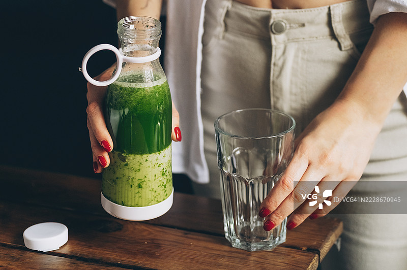 孕妇将生食材放入搅拌机中制作新鲜自制水果奶昔图片素材