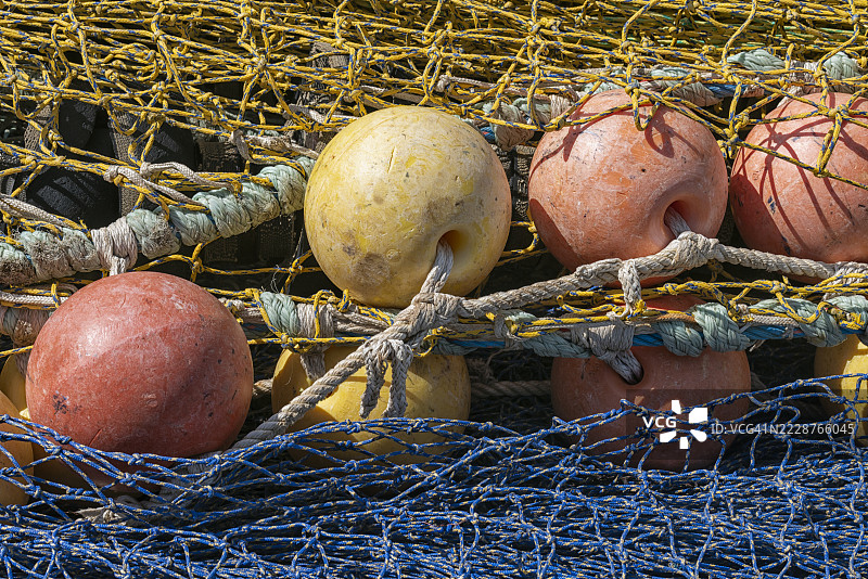 全景照片展示蓝色和黄色的渔网，配有红色和黄色的浮标。图片素材