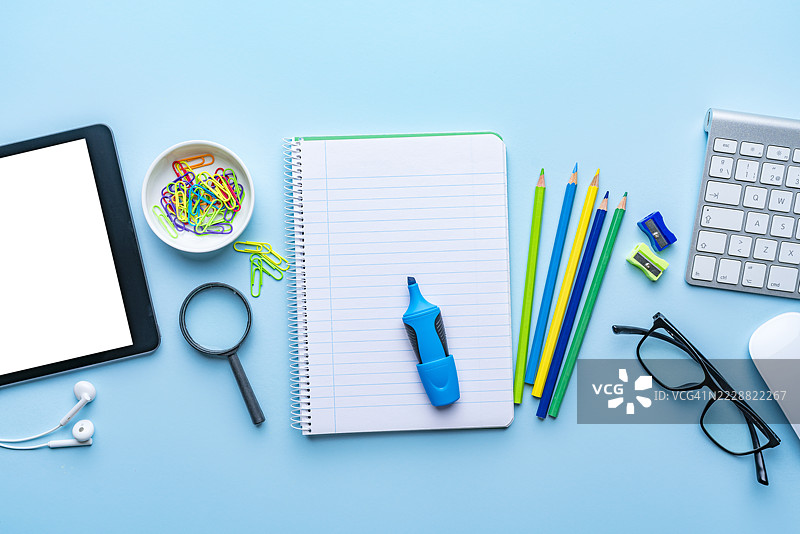 学校或办公室用品的横幅，从上方拍摄，平铺。电脑键盘、数字平板和鼠标，工作或返校背景。图片素材